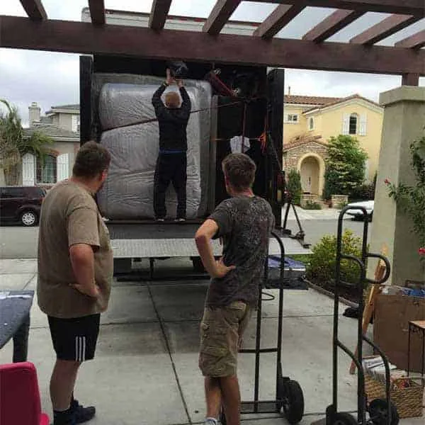 Cali Moving and Storage workers loading the truck with packed items